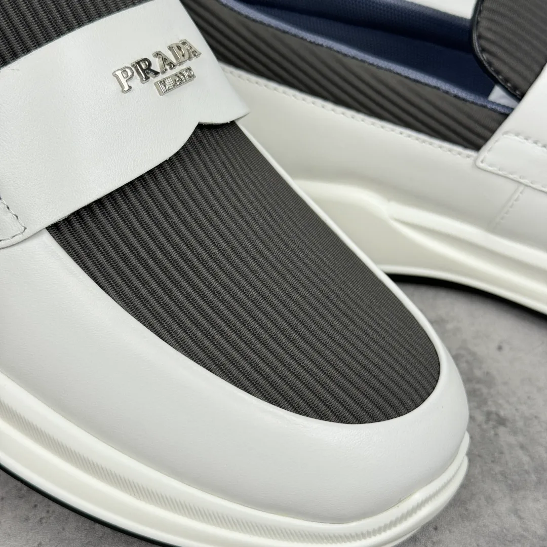 Batch 700 Prada/Prada men's matte leather thick-soled lightweight loafers! Casual fit, lightweight rubber sole slip-on driving shoes, matte calfskin wrapped around the entire upper, front body in pebbled calfskin/soft cloth, two styles available! Decorated with genuine leather buckle, front decorative details of PRADA silver letters, genuine leather feet, classic silver letter logo badge details, technical mesh lining, push-on opening and closing method, convenient and comfortable, cool and breathable! Paired with a lightweight, sporty functional thick sole, it is extremely comfortable on the feet and will not be tiring after long-term wear. It is available in multiple colors to meet different matching needs and comes with a complete package! Size: 39-40-41-42-43-44 Leather shoe size Item number: 2EE915 leather cloth white gray